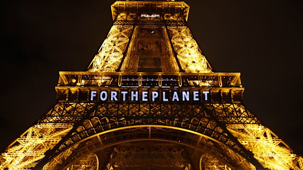The slogan 'FOR THE PLANET' is projected on the Eiffel Tower as part of the COP21, United Nations Climate Change Conference in Paris. (AAP)