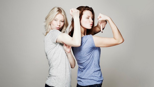 Women flexing their arm muscles