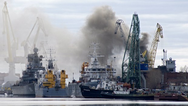 Smoke rises from a dock where the Russian Orel nuclear submarine is reportedly on fire. (AFP)