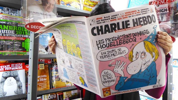 A woman reads the latest issue of French satirical newspaper 'Charlie Hebdo' in a bookshop in Paris, France. (AAP)