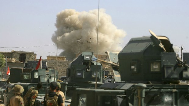 Smoke rises after airstrikes by U.S.-led coalition warplanes as Iraqi security forces advance their positions during heavy fight against Islamic State extremists in Fallujah. (AAP)