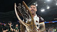 Adam Reynolds of the Broncos poses with the premiership trophy.