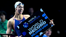 Gretchen Walsh of United States of America shows the cheque for $25,000 received for setting the world record.