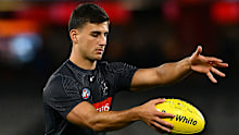 Nick Daicos of the Magpies warms up.