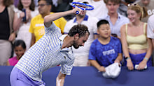 Daniil Medvedev breaks his racquet after losing in five sets to Benjamin Bonzi.