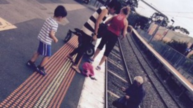 Witnesses have rescued a toddler who rolled onto train tracks at Diamond Creek while strapped into her pram. (Twitter @ashbown_)