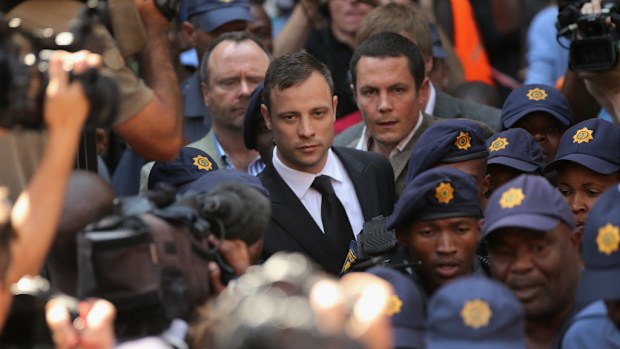Oscar Pistorius struggles through the crowd as he leaves court. (Getty)
