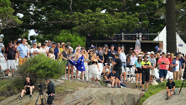 Crowds watch on foot at Sydney's Shark Island. 
