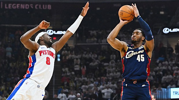 Donovan Mitchell of the Cleveland Cavaliers shoots the ball against Caris LeVert of the Detroit Pistons.