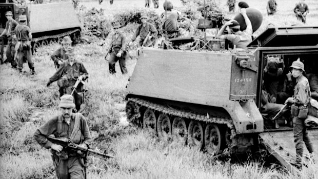 Australian soldiers sweep the field the day after the battle of Long Tan in Vietnam. (AAP)