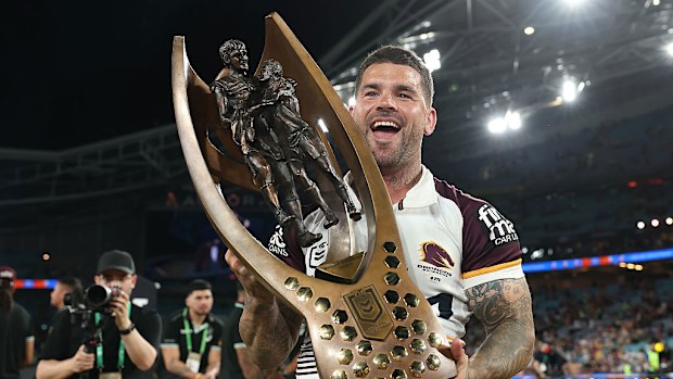 Adam Reynolds of the Broncos poses with the premiership trophy.