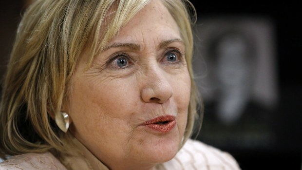 Former Secretary of State Hillary Rodham Clinton speaks with a customer at a signing for her book Hard Choices. (AP Photo/Steven Senne)
