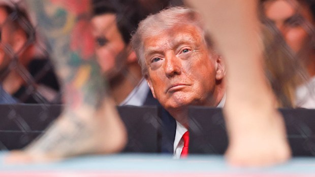 President Donald Trump watches a featherweight bout during UFC 327.