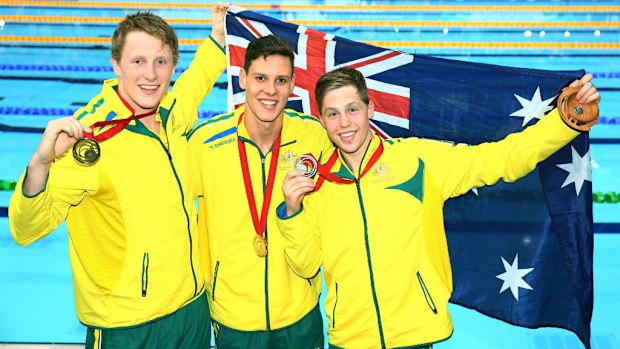 Australian gold medallist Mitch Larkin poses with silver medallist Josh Beaver (right) and bronze medallist Matson Lawson (left) after the medal ceremony for the men's 200m backstroke.