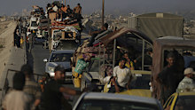 Displaced Palestinians fleeing northern Gaza Strip move with their belongings along the Sea Road, near Wadi Gaza, Saturday, August 30, 2025.