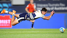 Payton Spencer of the Blues scores a try.