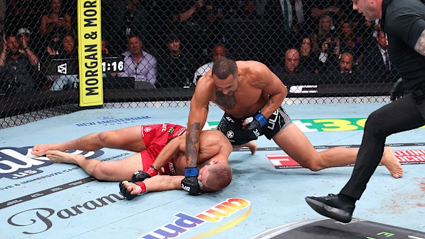 Carlos Ulberg celebrates winning the UFC light heavyweight championship fight.