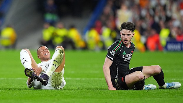 Declan Rice of Arsenal looks on whilst Kylian Mbappe of Real Madrid lays on the pitch.