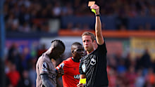 John Brooks shows a red card to Yves Bissouma of Tottenham Hotspur.