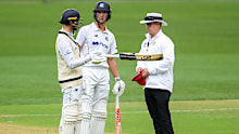 Umpire Nathan Johnstone confirms to Peter Handscomb he is out.