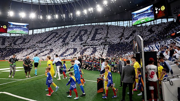 A tifo reads "To Dare Is To Do" as the players walk out.