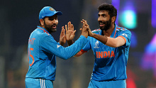 MUMBAI, INDIA - NOVEMBER 15: Jasprit Bumrah of India celebrates with teammate Rohit Sharma after dismissing Glenn Phillips of New Zealand (not pictured) during the ICC Men's Cricket World Cup India 2023 Semi Final match between India and New Zealand at Wankhede Stadium on November 15, 2023 in Mumbai, India. (Photo by Robert Cianflone/Getty Images)