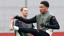 Leonard Prescott of Bayern Munich warms-up next to his teammate Manuel Neuer.