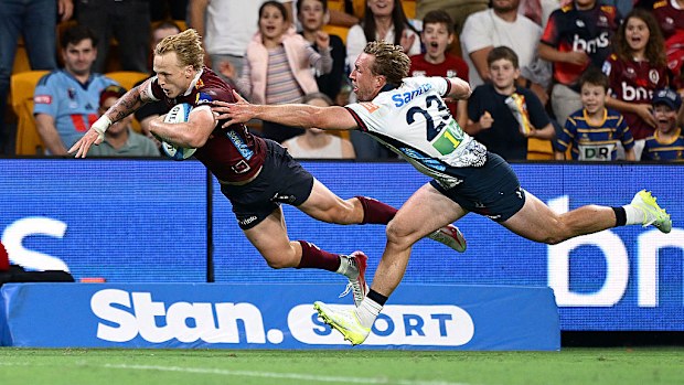 Carter Gordon of the Reds scores a try.