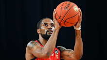 Bryce Cotton of the Wildcats shoots.