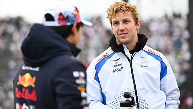 Yuki Tsunoda of Oracle Red Bull Racing and Liam Lawson of Visa Cash App Racing Bulls talk on the drivers parade prior to the F1 Grand Prix of Japan.