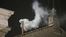 White smoke is seen billowing out from the chimney of the Sistine Chapel and announcing that a new pope has been elected on March 13, 2013.