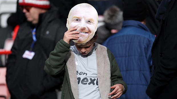 A young Nottingham Forest fan wearing a mask of Sean Dyche.
