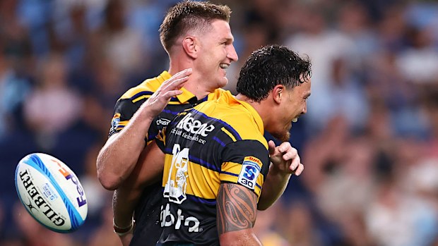 Billy Proctor of the Hurricanes celebrates scoring a try with teammate Jordie Barrett.