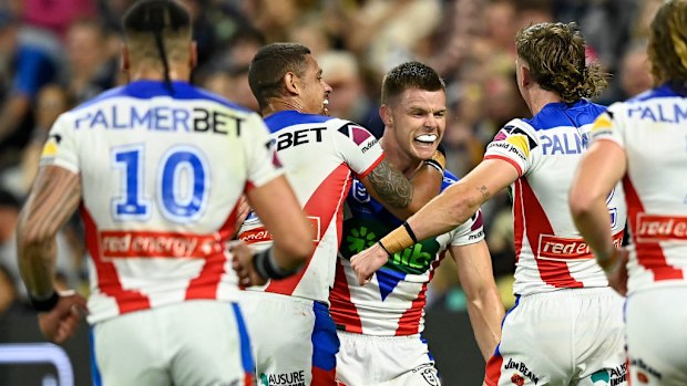 Knights players celebrate scoring a try.