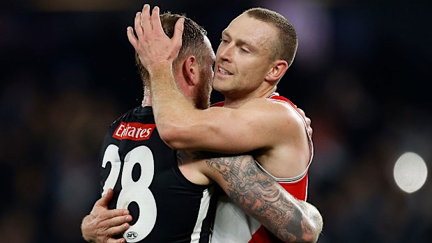 Tim Membrey of the Magpies and Callum Wilkie of the Saints embrace.