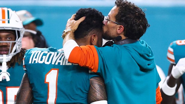 Head coach Mike McDaniel of the Miami Dolphins embraces Tua Tagovailoa #1 after leaving the game with an injury.