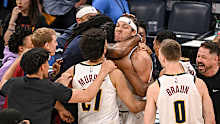 Aaron Gordon (32) of the Denver Nuggets sneers as teammates mob him after hitting a game-winning jumper over Chet Holmgren (7) of the Oklahoma City Thunder.