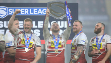 Jackson Hastings lifts the League Leaders' Shield during his time at Wigan. 