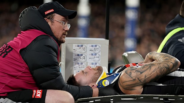 Jeremy Howe of the Magpies leaves the ground on a stretcher.