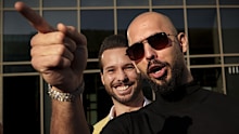 Andrew Tate gestures, next to his brother Tristan, outside the Bucharest Tribunal in Bucharest, Romania, Thursday, January 9, 2025. 