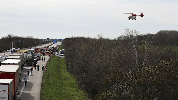 Emergency vehicles and a rescue helicopter work at the scene of the accident on the A9, near Schkeuditz, Germany, Wednesday, March 27. 2024 