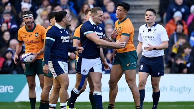 Joseph-Aukuso Suaalii of Australia clashes with Sione Tuipulotu of Scotland.