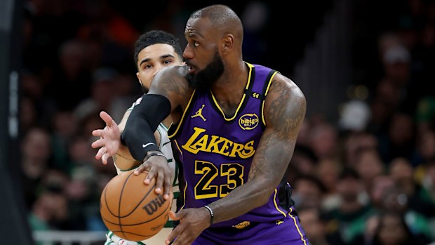 LeBron James #23 of the Los Angeles Lakers passes the ball as Jayson Tatum #0 of the Boston Celtics defends.
