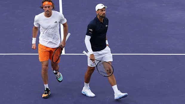 Novak Djokovic of Serbia (R) and Stefanos Tsitsipas between points against Arthur Rinderknech and Valentin Vacherot.