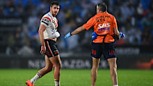 Paul Momirovski of the Roosters walks off injured.