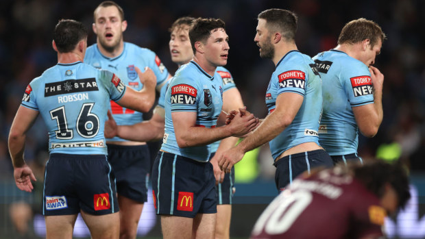 Mitchell Moses and James Tedesco of the Blues celebrate winning game three of the State of Origin series.