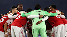 Players of Arsenal form a huddle prior to a Premier League match.