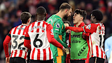 Tempers flare between Gianluigi Donnarumma (C) and Luke O'Nien (R).
