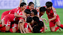 Players of DPR Korea celebrate their teammate Choe Il-Son's goal before it is cancelled by a VAR check.