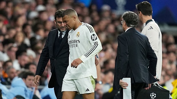 Kylian Mbappe of Real Madrid grimaces as he leaves the pitch after picking up an injury.